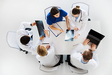 Image showing group of doctors with x-rays and laptop at clinic