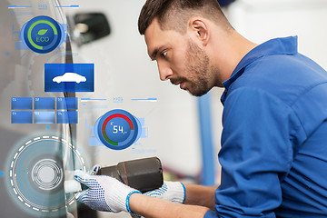 Image showing mechanic with screwdriver changing car tire