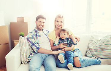 Image showing happy family with boxes moving to new home