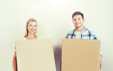 Image showing smiling couple with big boxes moving to new home