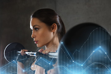 Image showing young woman flexing muscles with barbell in gym