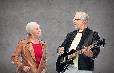 Image showing happy senior couple with electric guitar