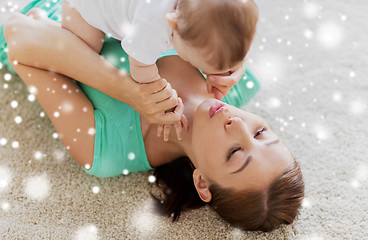 Image showing happy mother playing with little baby at home