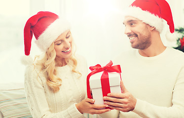 Image showing happy couple at home with christmas gift box