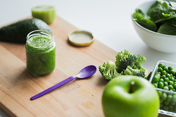 Image showing jar with puree or baby food on wooden board