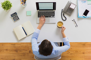 Image showing businesswoman with laptop and coffee at office