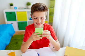 Image showing student boy with smartphone distracting from study