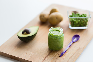 Image showing jar with puree or baby food on wooden board