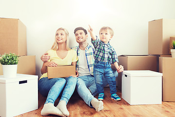 Image showing happy family with boxes moving to new home