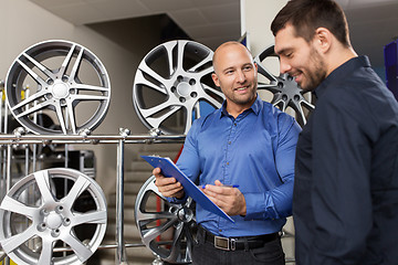 Image showing customer and salesman at car service or auto store