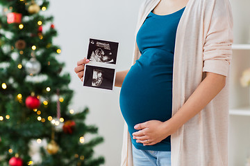 Image showing pregnant woman with ultrasound images at christmas