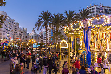 Image showing Christmas fair with carousel on Modernisme Plaza of the City Hall of Valencia, Spain.