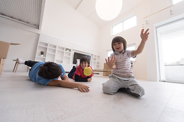 Image showing boys having fun with an apple on the floor