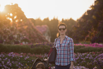 Image showing mother and daughter in flower garden