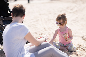 Image showing Mom and daughter on the beach