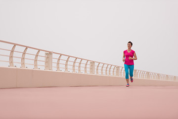 Image showing woman busy running on the promenade