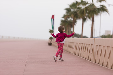 Image showing cute little girl on the promenade by the sea