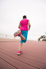 Image showing woman busy running on the promenade