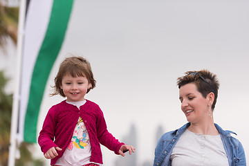 Image showing mother and cute little girl on the promenade