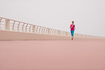 Image showing woman busy running on the promenade