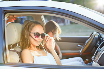 Image showing The young women in the car smiling