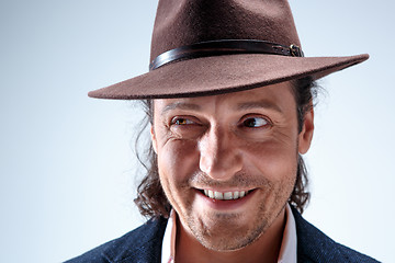 Image showing Young man portrait with hat on gray studio background.