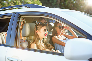 Image showing The young women in the car smiling