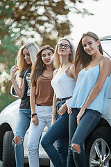 Image showing The young women standing near the car