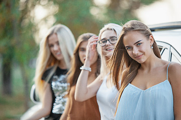 Image showing The young women standing near the car