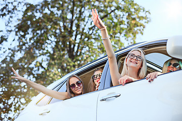 Image showing The young women in the car smiling