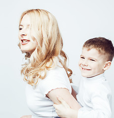 Image showing young modern blond curly mother with cute son together happy smiling family posing cheerful on white background, lifestyle people concept, sister and brother friends 