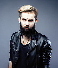 Image showing portrait of young bearded hipster guy on gray dark background close up, brutal modern man, lifestyle people concept 