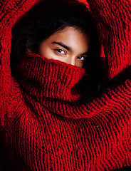 Image showing young pretty indian mulatto girl in red sweater posing emotional, fashion hipster teenage, lifestyle people concept 