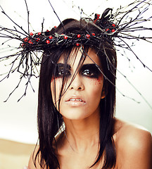 Image showing pretty brunette woman with make up like demon at halloween, clos