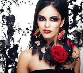 Image showing pretty brunette woman with rose jewelry, black and red, bright m