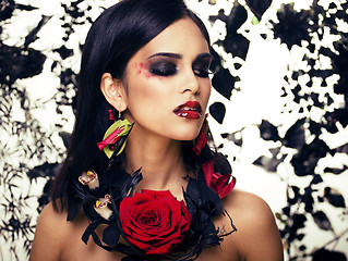 Image showing pretty brunette woman with rose jewelry, black and red, bright m