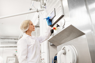 Image showing woman programming computer at ice cream factory