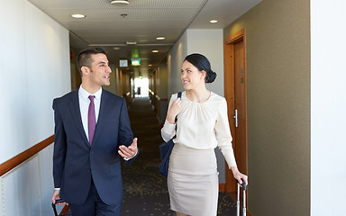 Image showing business team with travel bags at hotel corridor