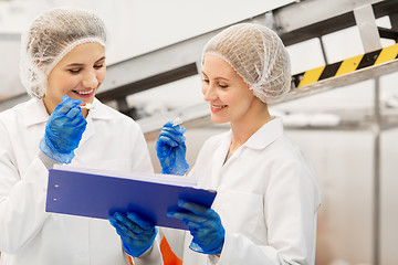 Image showing women technologists tasting ice cream at factory