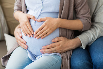 Image showing close up of pregnant woman making hand heart