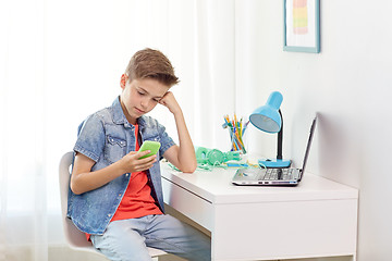 Image showing boy with smartphone being bullied by text message