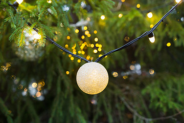 Image showing close up of christmas tree garland bulb outdoors