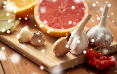 Image showing citrus, ginger, garlic and rowanberry on wood