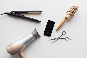 Image showing smartphone, scissors, hairdryer, iron and brush