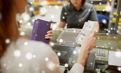 Image showing woman paying money at store cash register