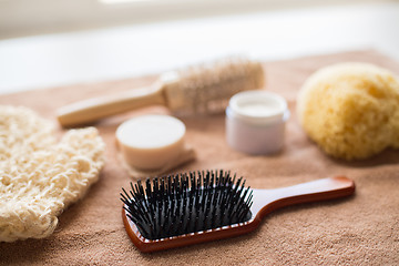 Image showing hair brush, cream, sponge, soap bar and bath towel