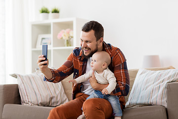 Image showing happy father with baby boy taking selfie at home