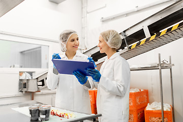 Image showing women technologists tasting ice cream at factory