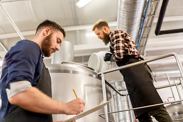 Image showing men working at craft brewery or beer plant