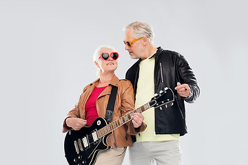 Image showing senior couple in sunglasses with electric guitar